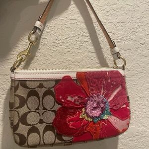 Small Coach purse with flower detail.
